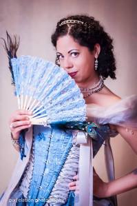 The author posing in a light blue and white corseted wedding gown made by MayFaire Moon.