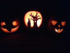 Image of 3 carved and lit Halloween pumpkins