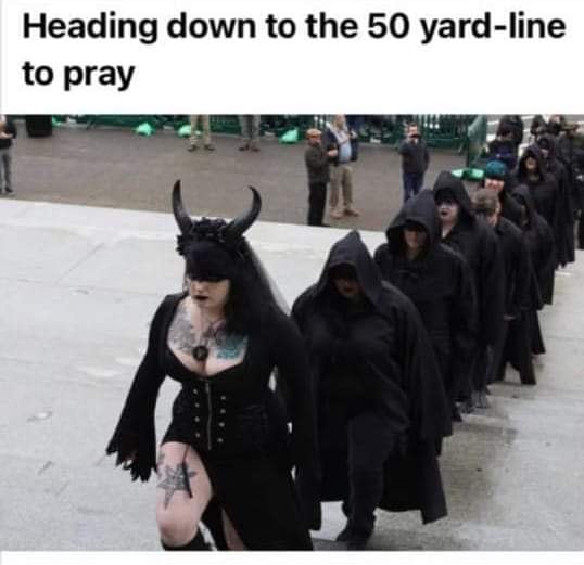 People with black hair, black clothes, and tattoos walking single file up concrete steps. Text reads: Heading down to the 50-yard line to pray.